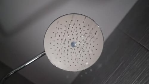 Modern Showerhead Streams Water in Elegant Bathroom