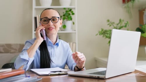 Woman Talking on Phone While at Desk