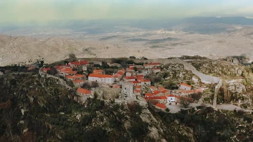 mountainous medieval historical city inside castle walls, dolly out aerial