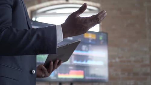 Businessman explaining data on screen during meeting with digital tablet