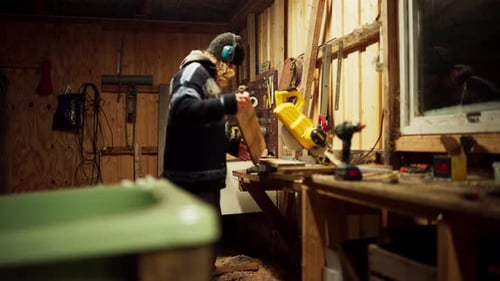 Woodworker Using Power Saw in Indoor Workshop