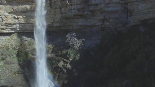 4k drone footage of a waterfall in a majestic mountain range