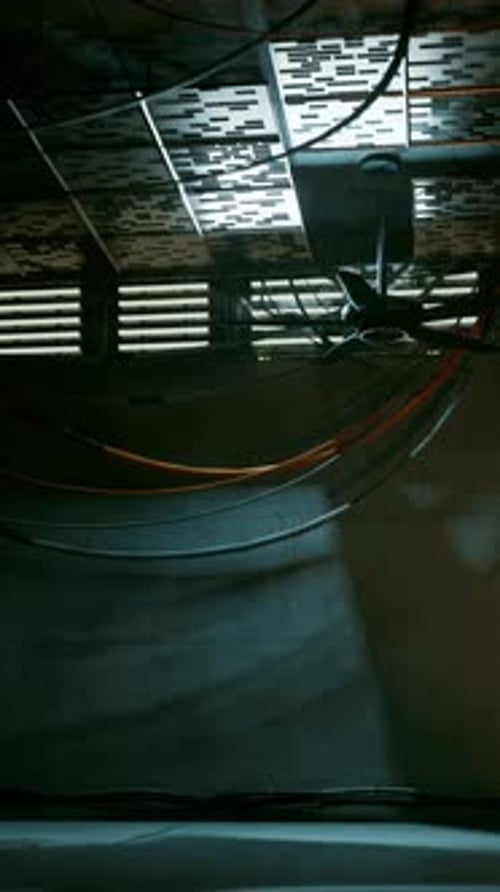 A Dimly Lit Room with a Staircase and Exposed Wires