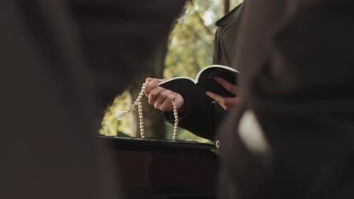 Sacerdote rezando en la ceremonia fúnebre