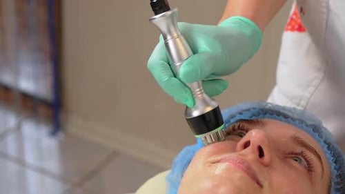 Woman Receiving Cosmetic Facial Treatment