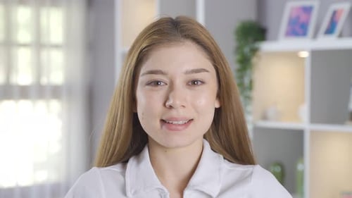 Smiling Woman with Blonde Hair Posing Indoors