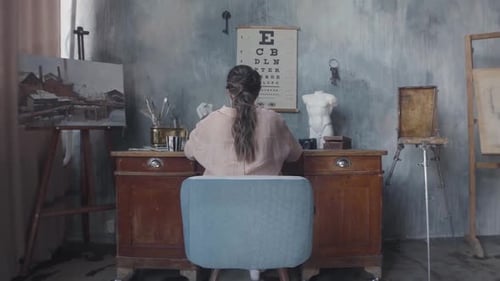 Artist Working at Desk in Art Studio