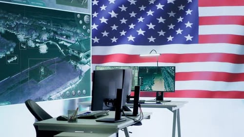 Office Workplace With American Flag and Computer Monitors