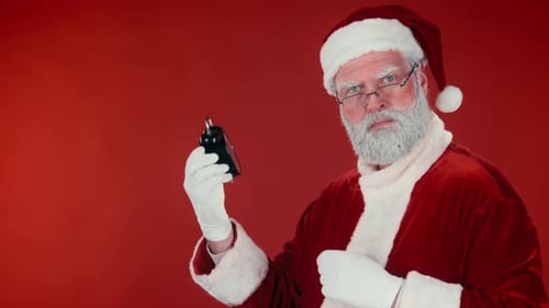 Santa Claus with Alarm Clock Against Red Backdrop