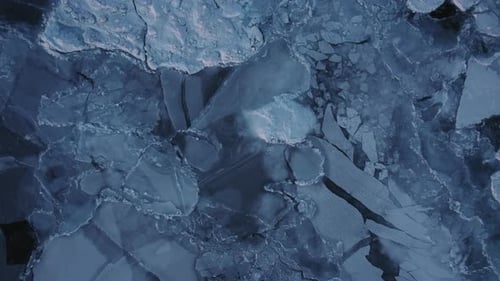 Overhead View Of Fragments Of Ice Scattered On The Vast Sea