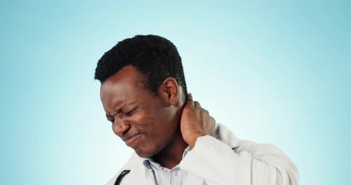 Black man, doctor and neck pain with burnout, stress and inflammation on a blue studio background