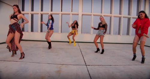 Five Women Dancing on Rooftop in Urban Setting