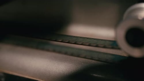Close-Up Of Filmstrip In Motion On Vintage Analog Projector