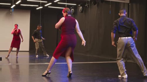Multiethnic Couple Dancing Tango Indoors