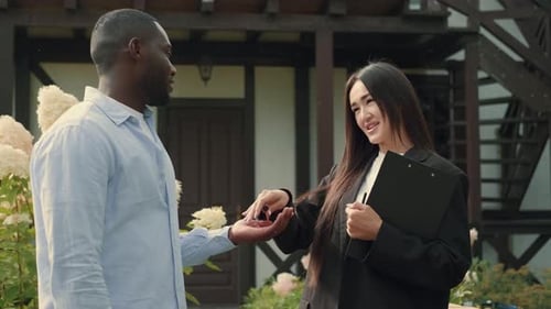 Asian Woman Real Estate Agent Sells a House to an African Man and Gives the Keys