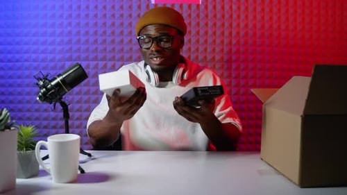 Man unpacks technology at desk