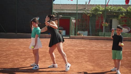 Tennis Teacher And Children At Sports Training School
