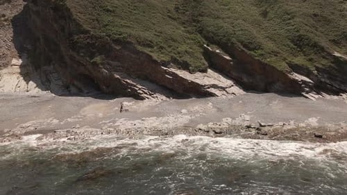 Adult Woman and Man Going for a Walk on the Beach in Northern Spain