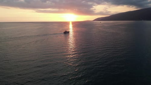 Aerial View of a Yacht Sailing at Sunset in the Middle of the Sea Concept of Travel and Holidays
