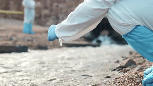 Researchers Collect Water Samples in Protective Suits