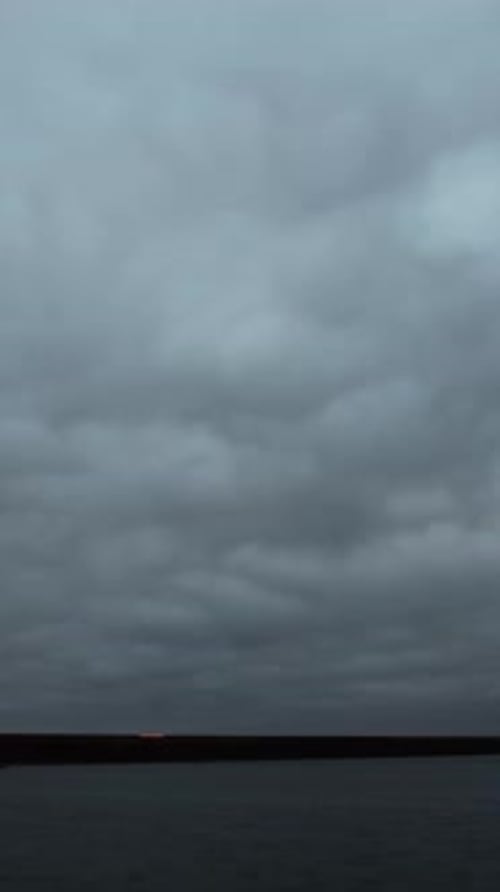 Gloomy Clouds Over Water Horizon