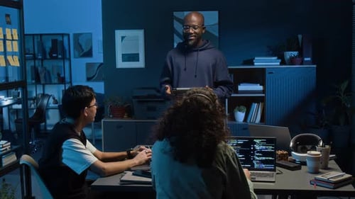 Young Web Engineer with Digital Tablet Speaking in Front of Two Gen Z Colleagues