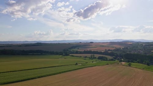 Aerial View of Countryside Area with Agricultural Fields Near Mountains