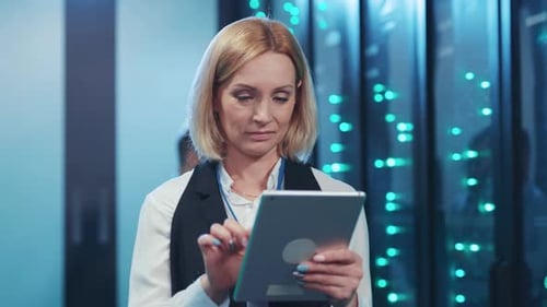 Woman Using Tablet in a Bright Server Room