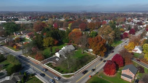 Aerial of small town residential houses and homes in autumn. Orbit on autumn day.