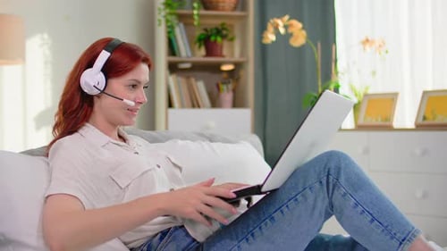 Young Woman Video Conferencing on Laptop at Home