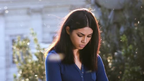 Young Woman Posing Outdoors in Sunlight