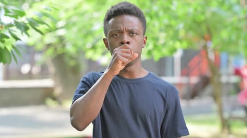 Portrait of Sick Casual African Man Coughing Outdoors