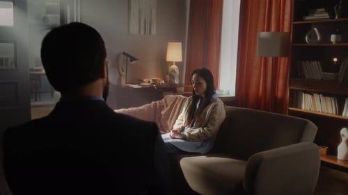 Woman talking with person in living room