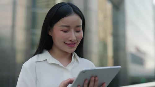 Young Woman Using Tablet in Urban Setting