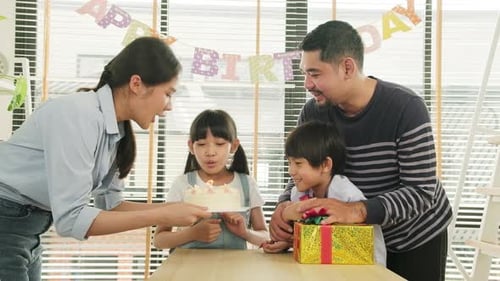 Family celebrates a birthday at home