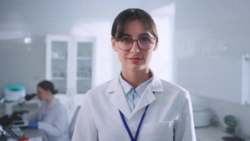 Woman Scientist Smiling in Bright Modern Lab