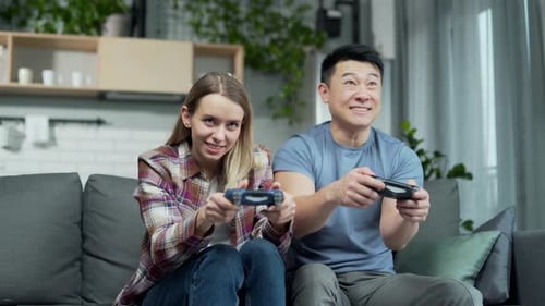 Young Couple Playing Video Games at Home