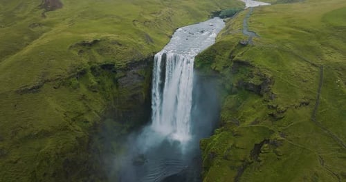 Aerial view of skogafoss waterfall and lush landscape, Iceland.