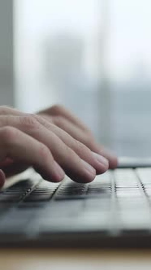 Hands Typing on Laptop Keyboard Close Up