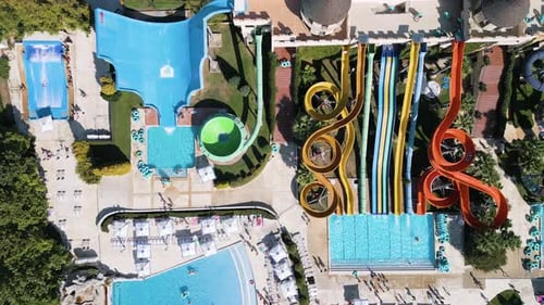 Stunning Drone View of a Massive Water Park Filled with Colorful Slides Pools Splash Zones and