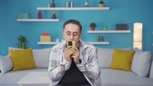 The man who happily puts the phone to his heart.