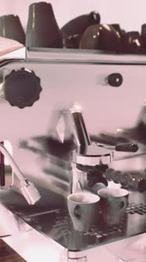 Espresso Machine Brewing Coffee into Two Cups