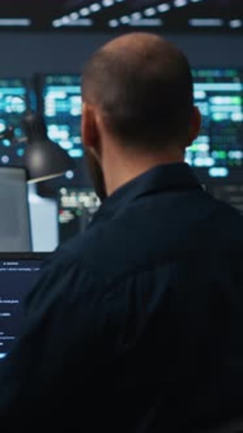 Software Developer Coding at Night in Bright Office