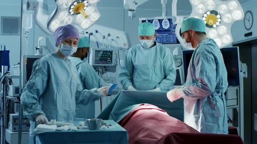 Diverse Team of Professional Surgeons Performing Invasive Surgery on a Patient in the Hospital Oper