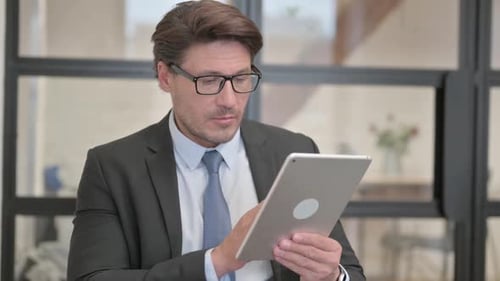 Adult Using Tablet in Workplace