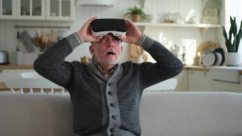 Senior Man Using Virtual Reality Headset at Home