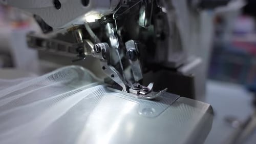 Sewing Machine Stitching White Fabric in Close Up