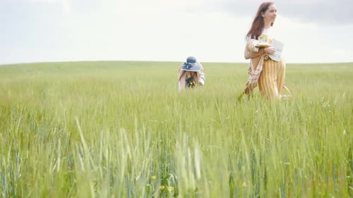 Two Women Walking on a Bright Green Meadow