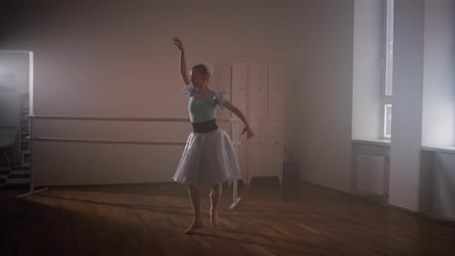 Blond Ballerina Dancing Gracefully in Ballet Studio