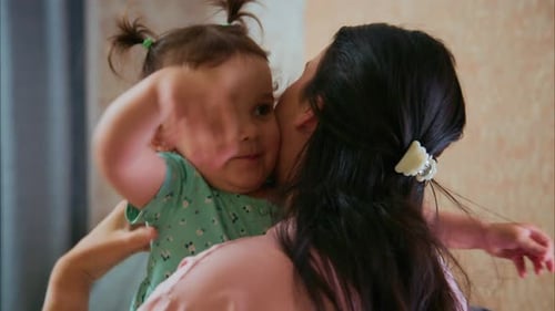 Mother and Child Hugging Affectionately Indoors